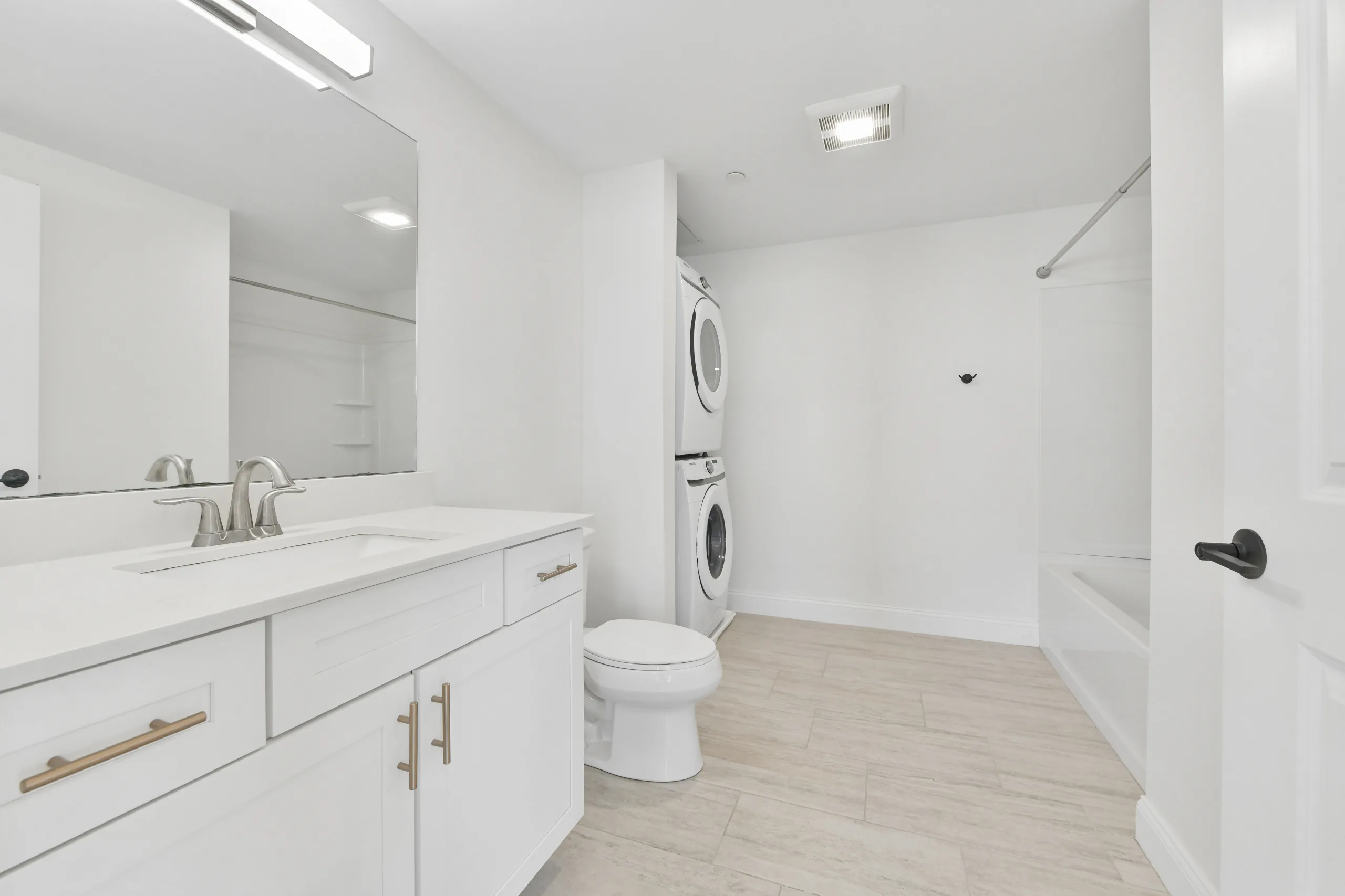 Bathroom with vanity, bath and in-unit laundry at 55 Monk St