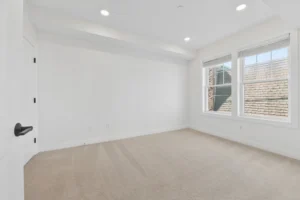 Carpeted bedroom with twin windows at 55 Monk St