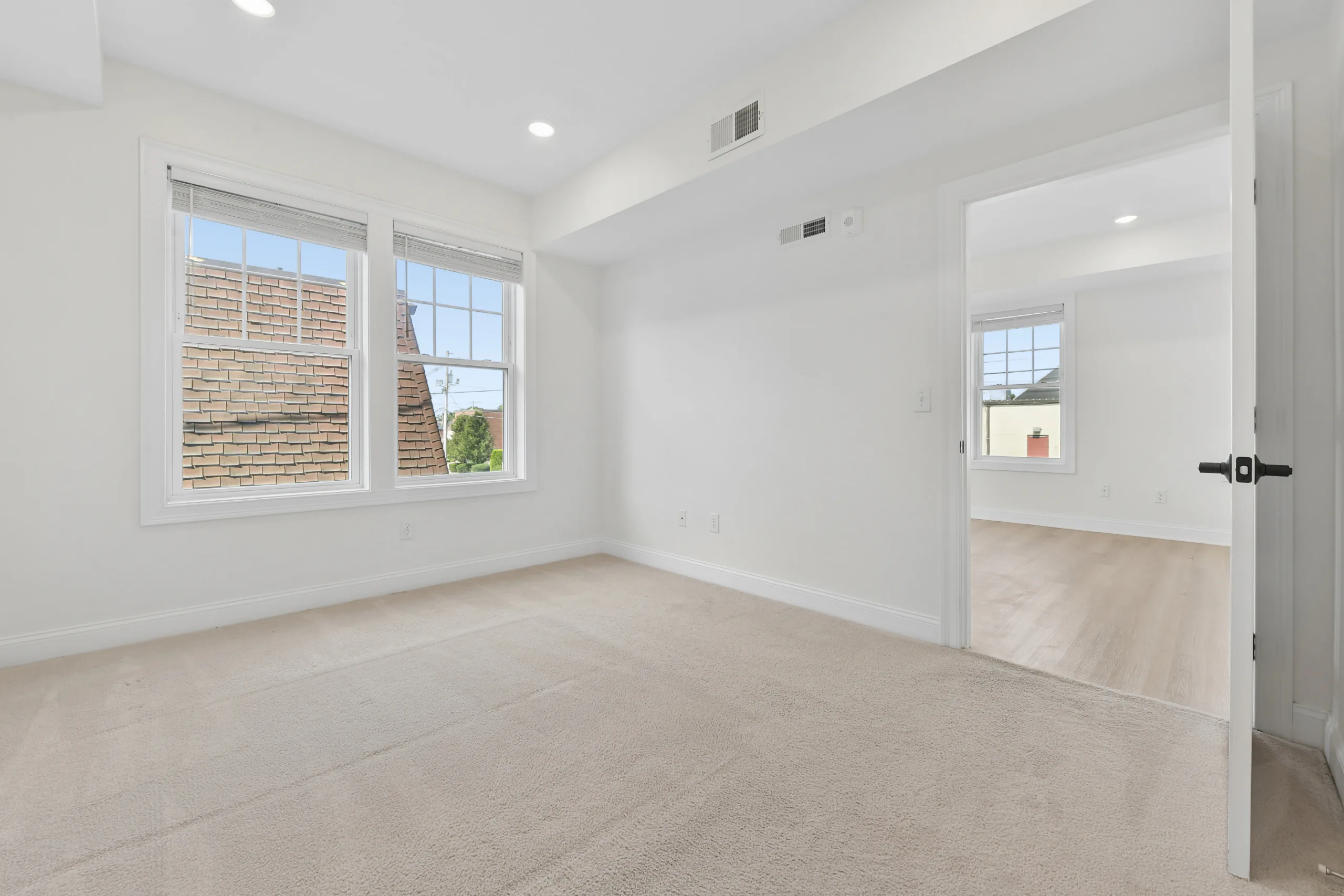 Carpeted bedroom with hallway access at 55 Monk St
