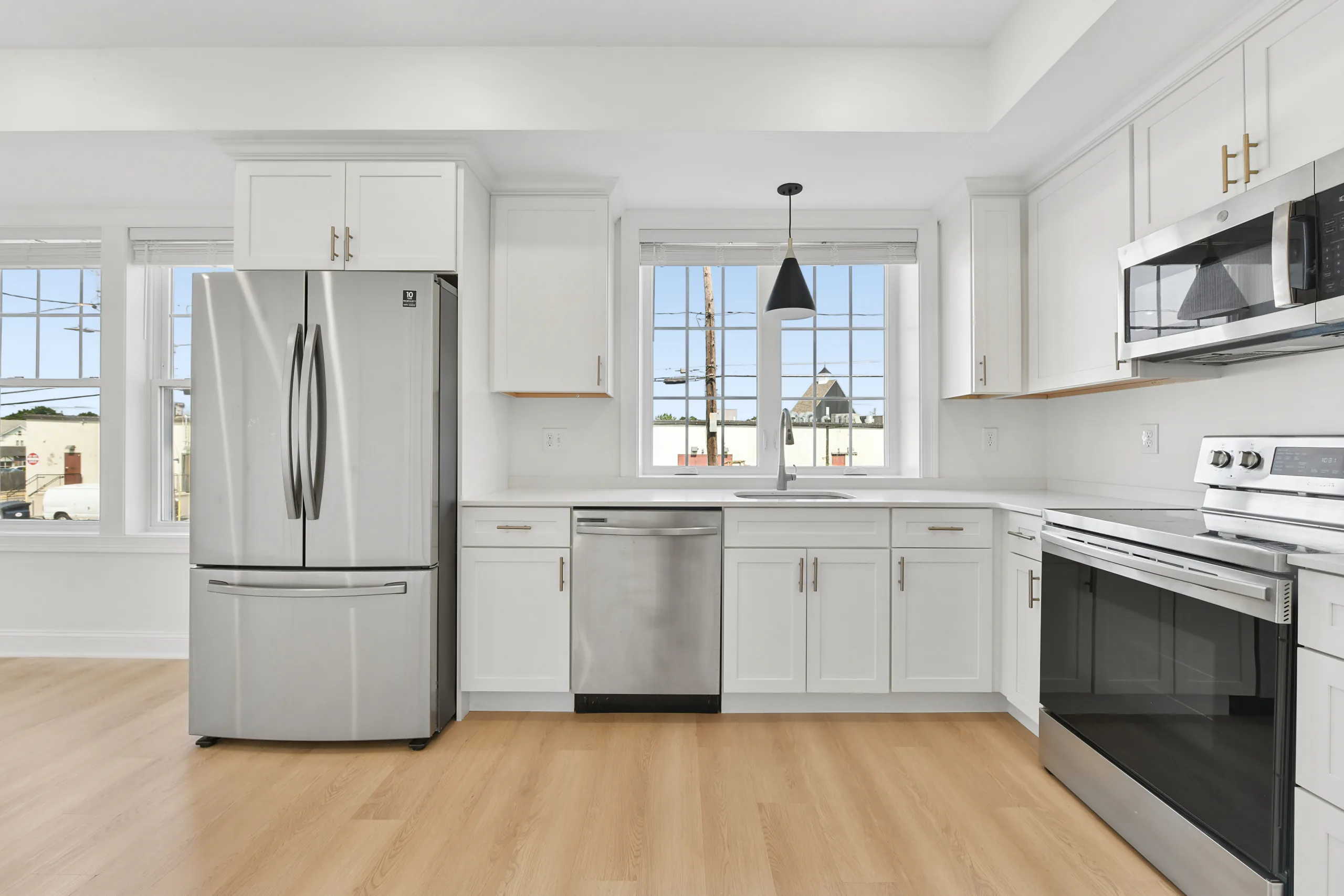 Kitchen with stainless steel appliances and white shaker cabinets at 55 Monk St