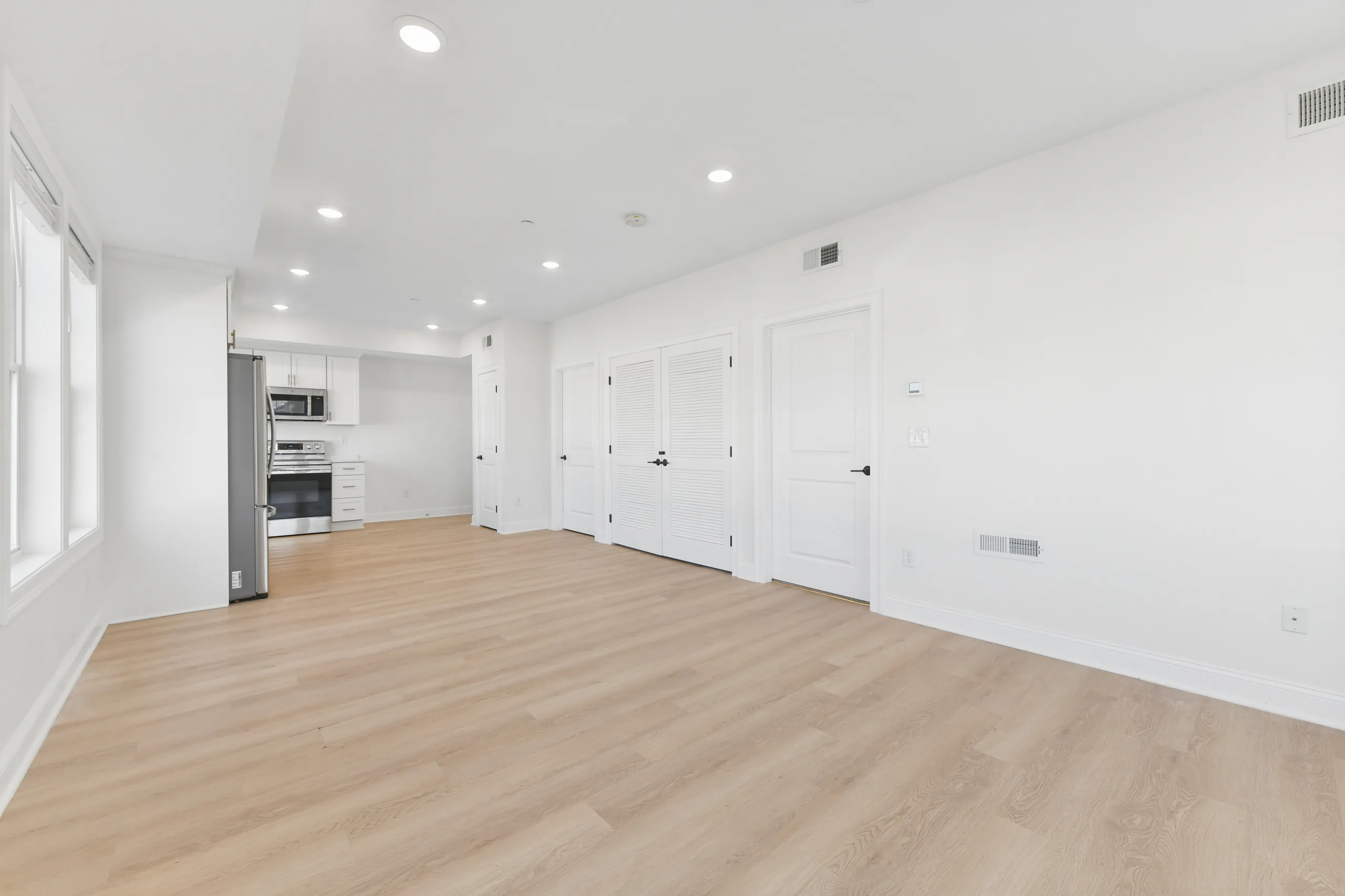 Open living space with wide-plank flooring at 55 Monk St
