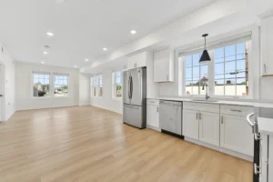 Open-plan kitchen and living area with hardwood floors at 55 Monk St